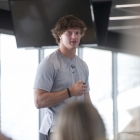 Kelby Telander speaking at UISPEAKS camp kinnick tour 2022, photo by jtobin