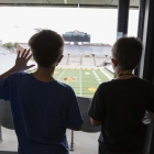 Kids overlooking Kinnick field at UISPEAKS camp kinnick tour 2022, photo by jtobin