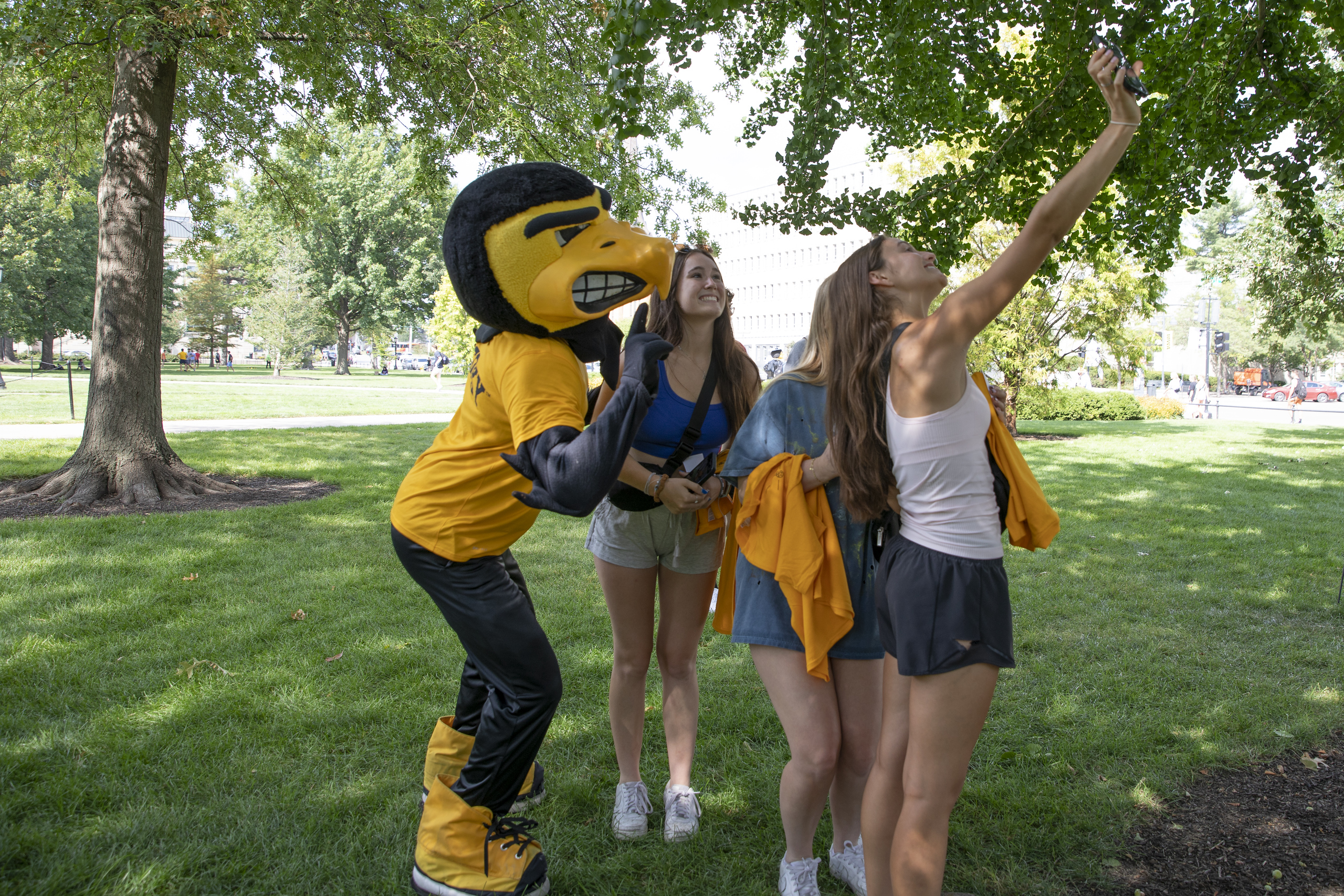 students taking a selfie on the Pentacrest with Herky