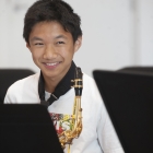 Student happy playing during Iowa Summer Music Camps, hosted by the UI School of Music.  