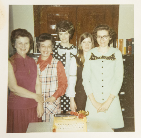 Driscol enjoys a typewriter cake with her colleagues.