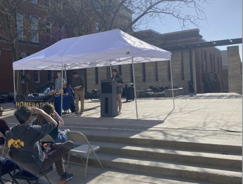 Student reading from Homer on T. Anne Cleary Walkway