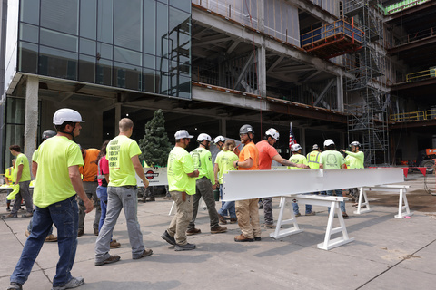 People celebrate the beam signing at the new Health Sciences Academic Building