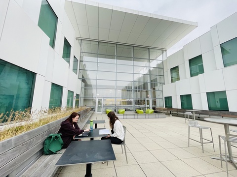 Students sit on the Voxman Terrace