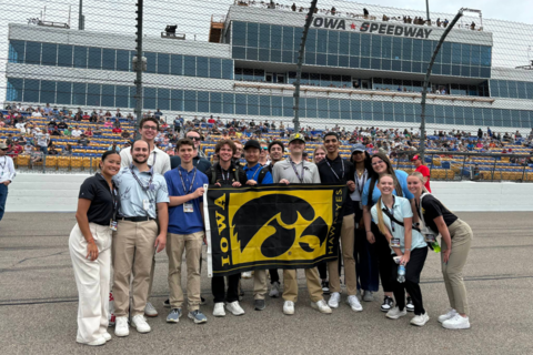 Students post on the NASCAR track