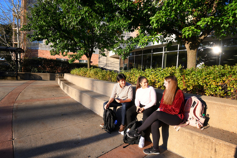 Students sit together