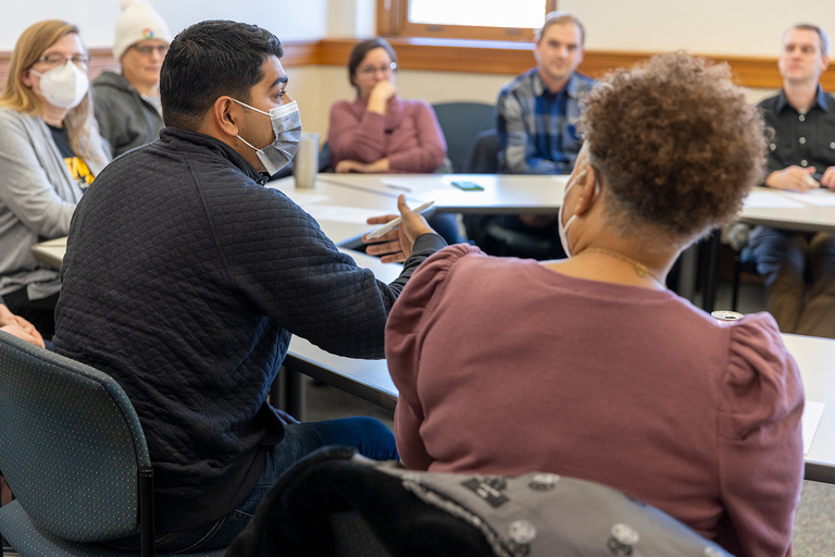 CLAS DEI Committee meets around a table