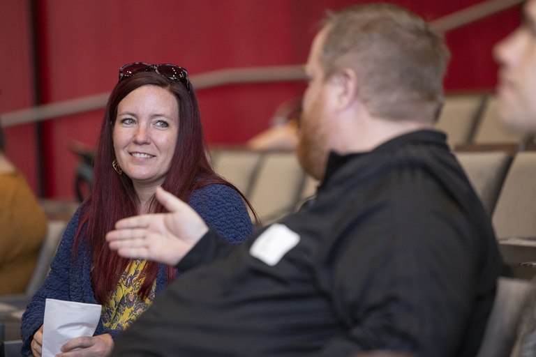 staff at the event listening and socializing